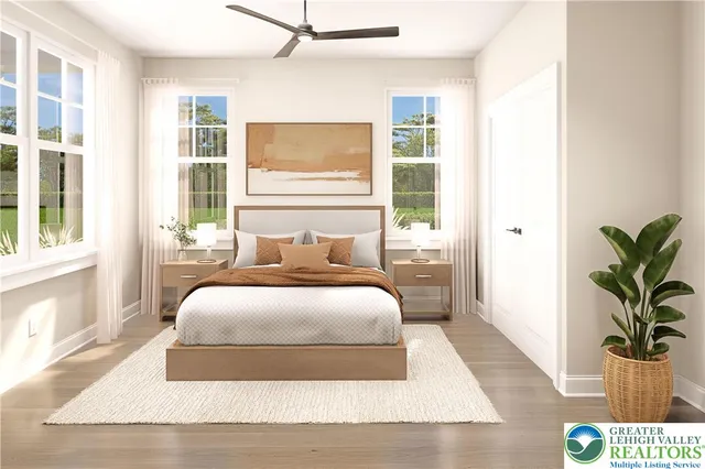 a bedroom with a large bed and a potted plant