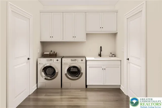 a utility room with sink dryer and washer