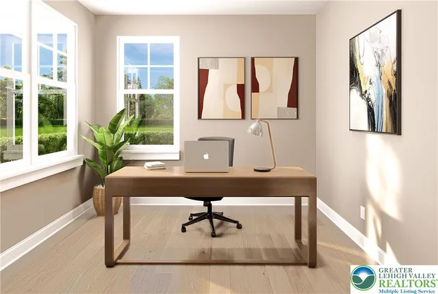 a view of a workspace with furniture and window