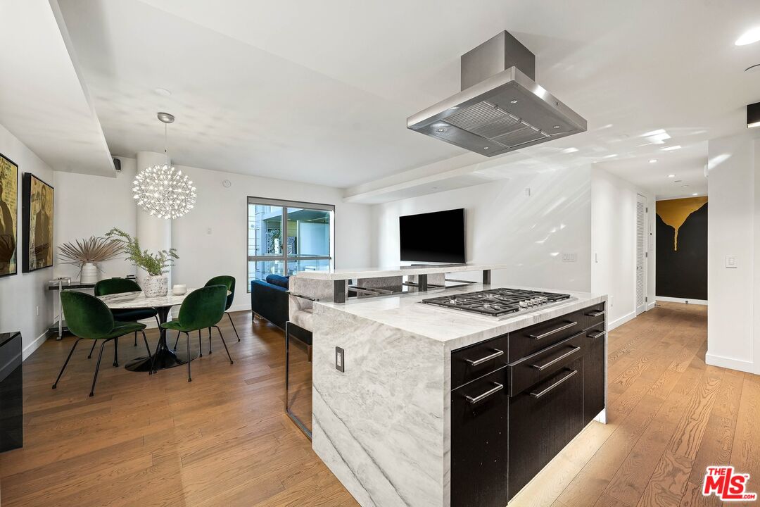 1755 Ocean Avenue, Unit 602 Santa Monica, CA 90401 - Photo 6 of 26 a large kitchen with kitchen island a sink table and chairs