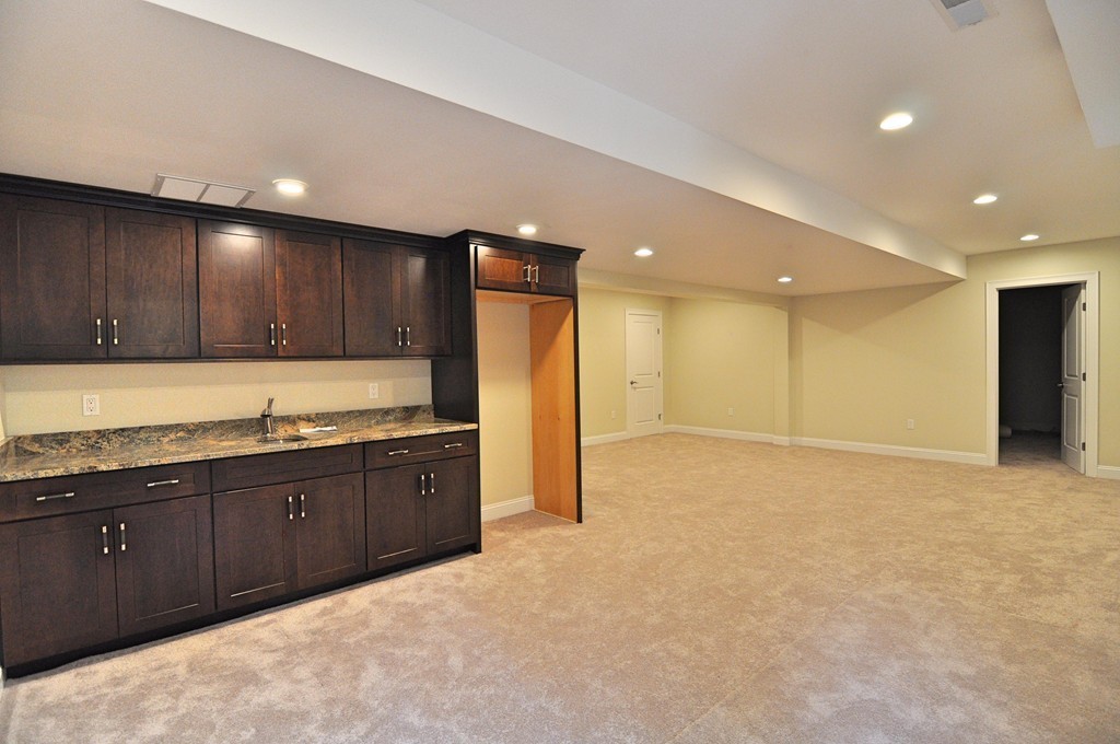 8 Maple Street Dunstable, MA 01827 - Photo 25 of 29 a large kitchen with stainless steel appliances granite countertop a sink and cabinets