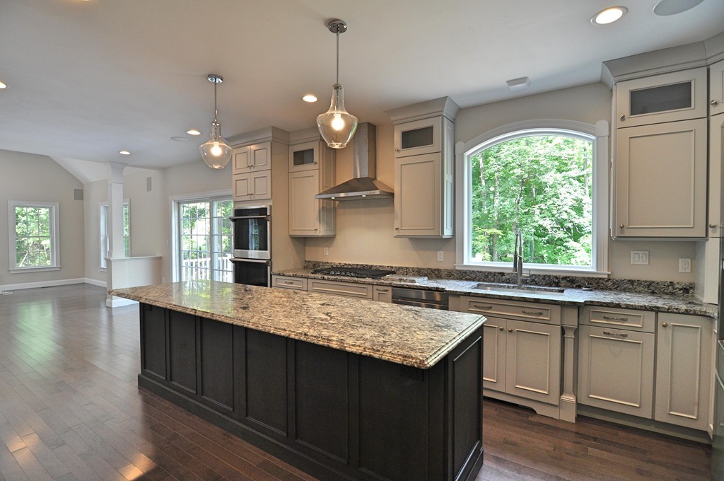 8 Maple Street Dunstable, MA 01827 - Photo 5 of 29 a kitchen with kitchen island granite countertop a sink stove and cabinets