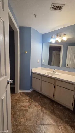 a bathroom with a double vanity sink and mirror