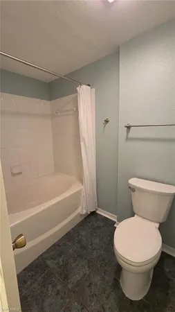 a bathroom with a toilet and a bathtub