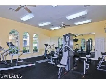 a front view of multiple houses with yard and green space