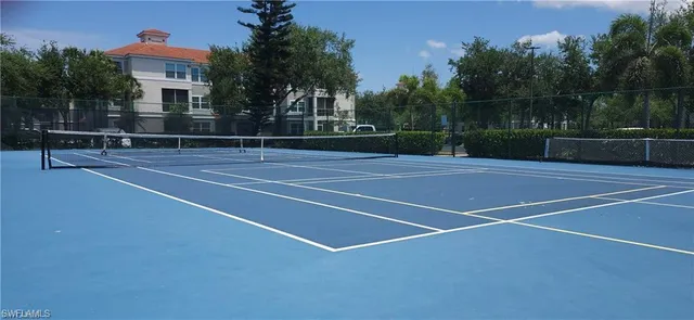 a kitchen with stainless steel appliances a stove a sink a window and white cabinets