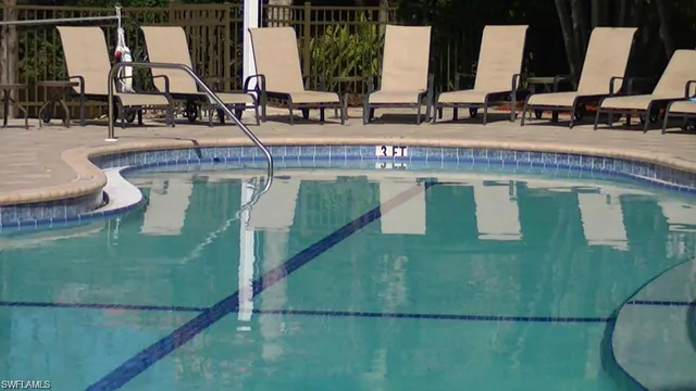 a view of a swimming pool with sitting area