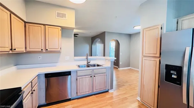 a kitchen with stainless steel appliances granite countertop a refrigerator and a sink