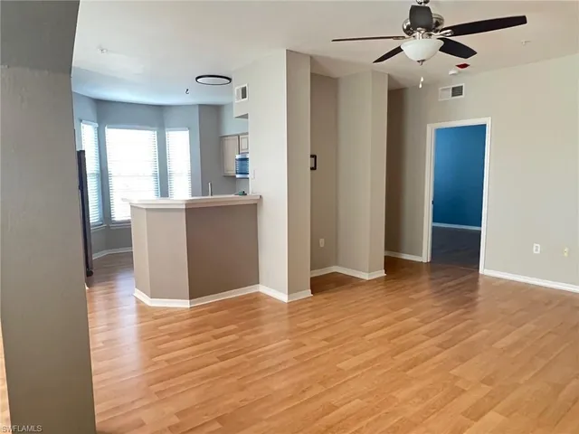 a view of a kitchen with wooden floor