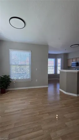 a view of a kitchen with wooden floor
