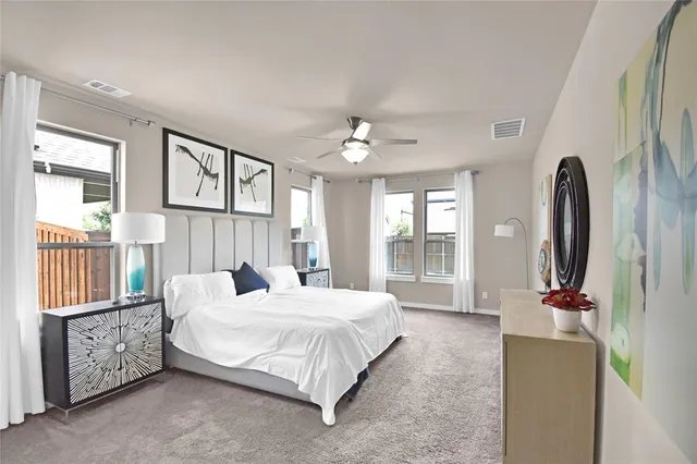 a bedroom with a bed couch and a window