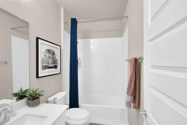 a bathroom with a shower a toilet and a sink