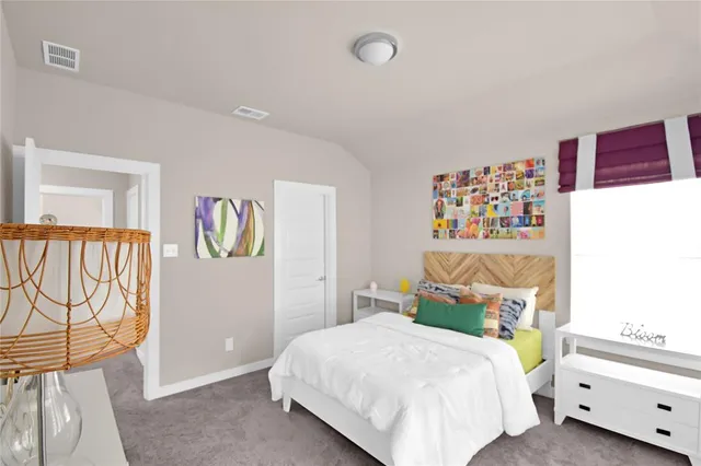 a bedroom with a bed and a painting on the wall