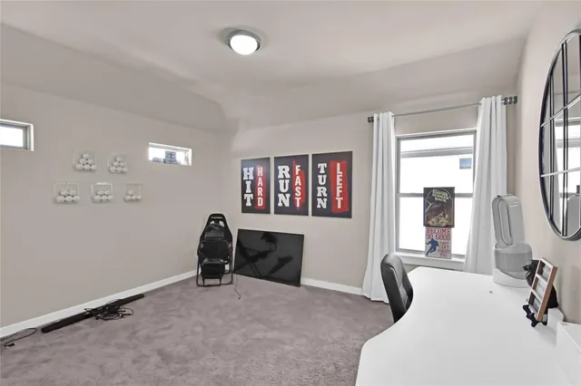 a view of a workspace with furniture and a window