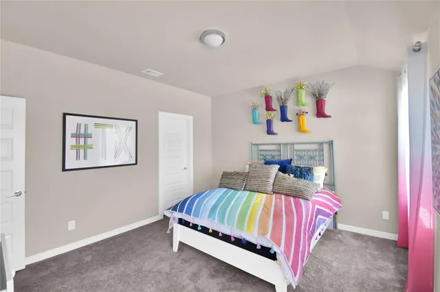 a bedroom with a bed and dresser