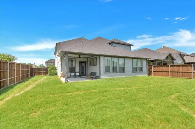 a view of a house with a backyard and porch