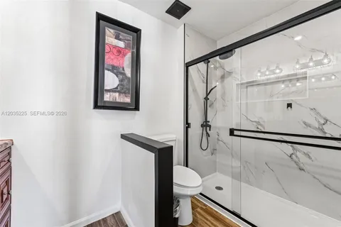 a bathroom with a shower and a toilet