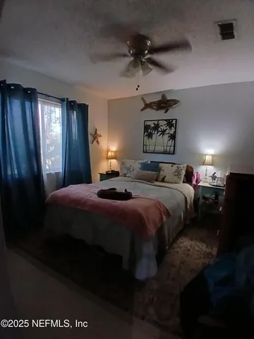 a bedroom with a bed and a mirror