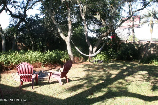 a backyard of a house with table and chairs