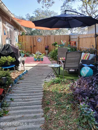 a view of a backyard with sitting area