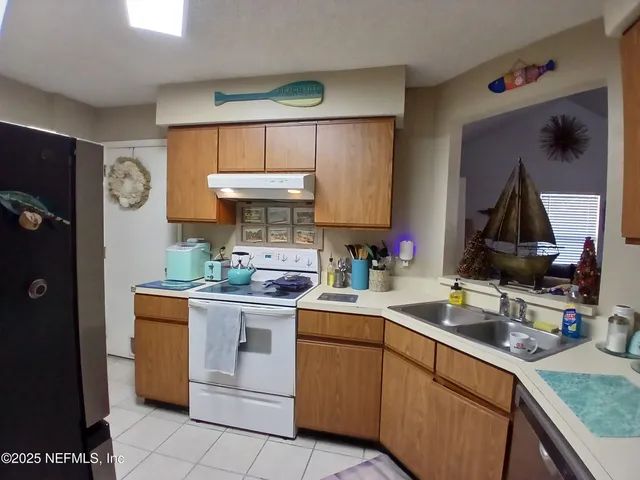 a kitchen with a sink cabinets and appliances
