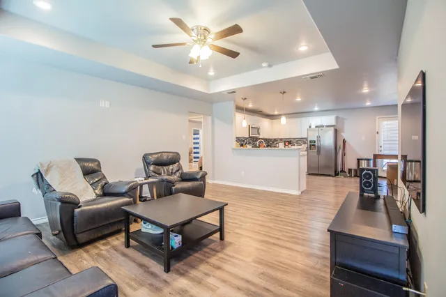 a living room with furniture and kitchen view