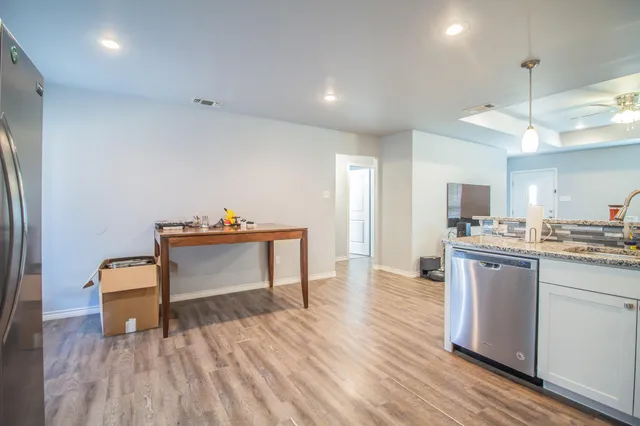 a room with wooden floor and furniture