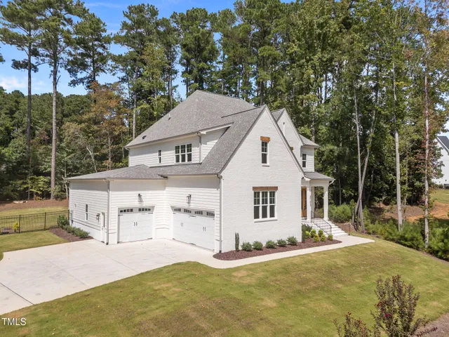 an aerial view of a house with a yard basket ball court and outdoor seating