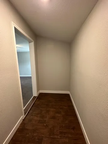 an empty room with wooden floor