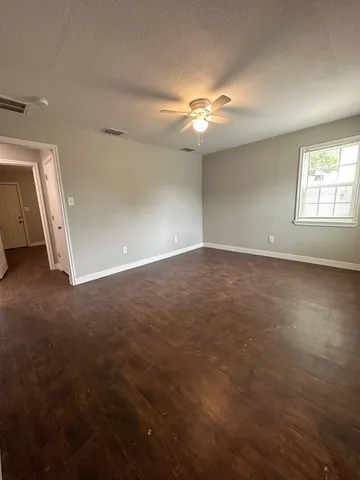 an empty room with a empty space and a ceiling fan
