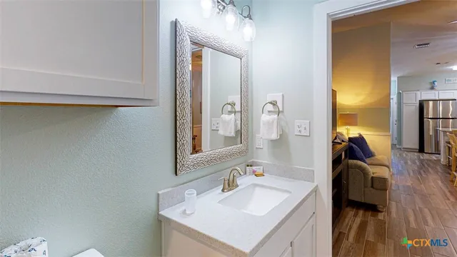 a en suite bathroom with a sink and a mirror