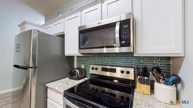 a kitchen with a stove and a microwave
