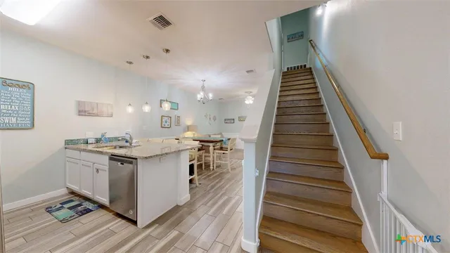a kitchen with sink stove and cabinets