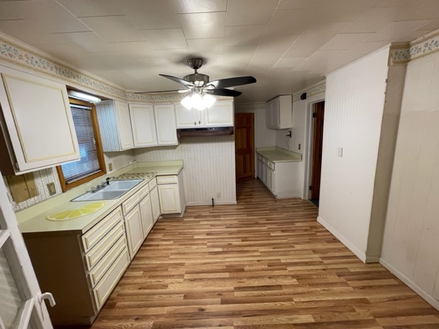 Undisclosed Address Maywood, IL 60153 - Photo 15 of 46 a large white kitchen with a sink dishwasher a refrigerator and a stove