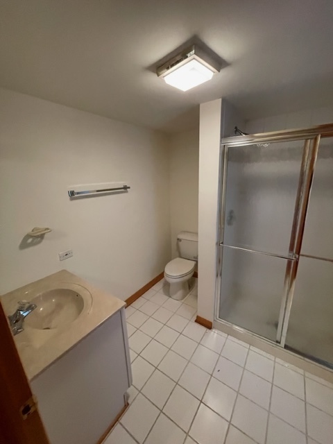 Undisclosed Address Maywood, IL 60153 - Photo 17 of 46 a bathroom with a sink toilet and shower