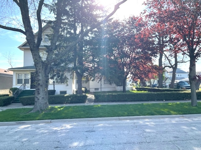 Undisclosed Address Maywood, IL 60153 - Photo 2 of 46 a front view of a house with garden