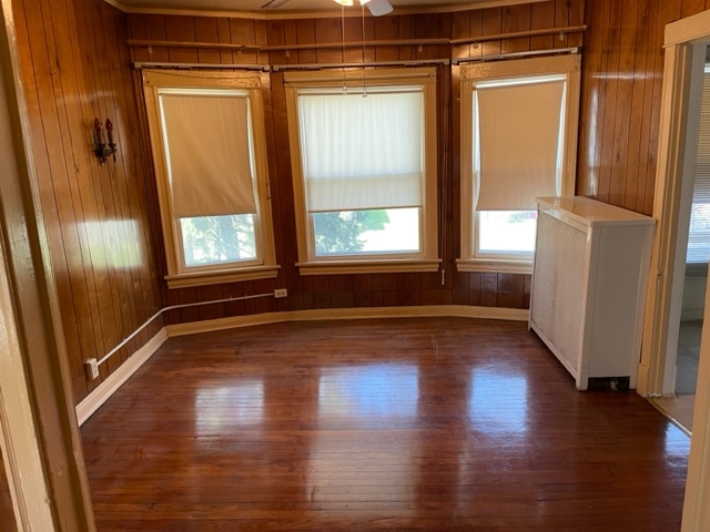 Undisclosed Address Maywood, IL 60153 - Photo 29 of 46 a view of an empty room with wooden floor and a window