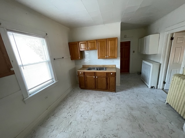 Undisclosed Address Maywood, IL 60153 - Photo 34 of 46 a view of a kitchen with a sink dishwasher and a refrigerator