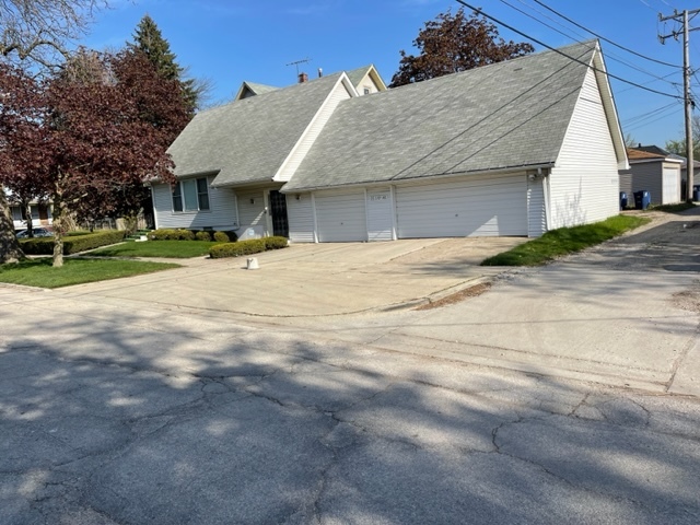 Undisclosed Address Maywood, IL 60153 - Photo 6 of 46 a view of a house with a yard and garage