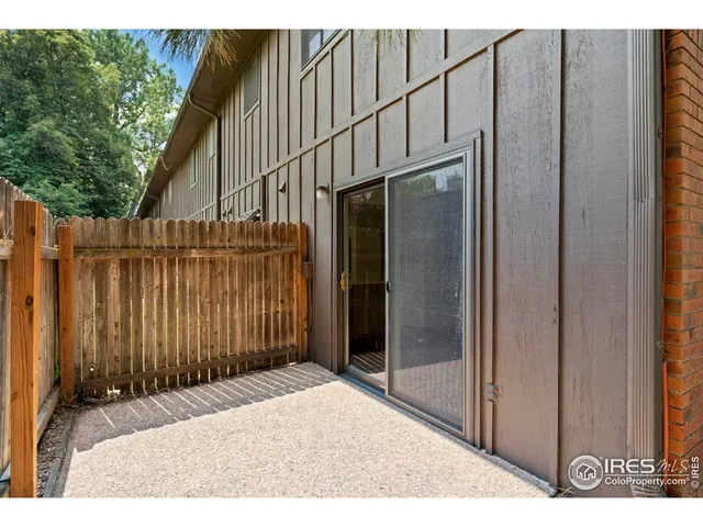 a backyard of a house with wooden fence