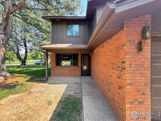 a view of a porch with a bench in front of house