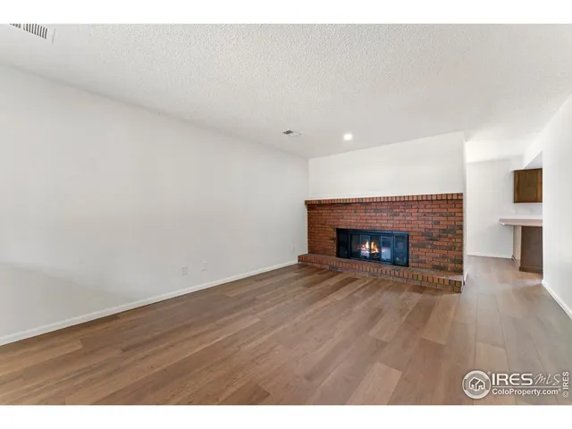 a view of an empty room and a fireplace
