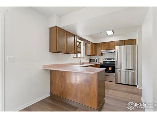 a kitchen with a refrigerator stove and sink