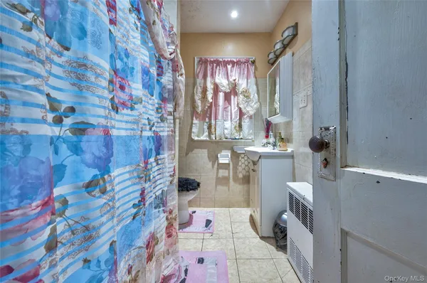 a dining room with stainless steel appliances furniture a window and a kitchen view