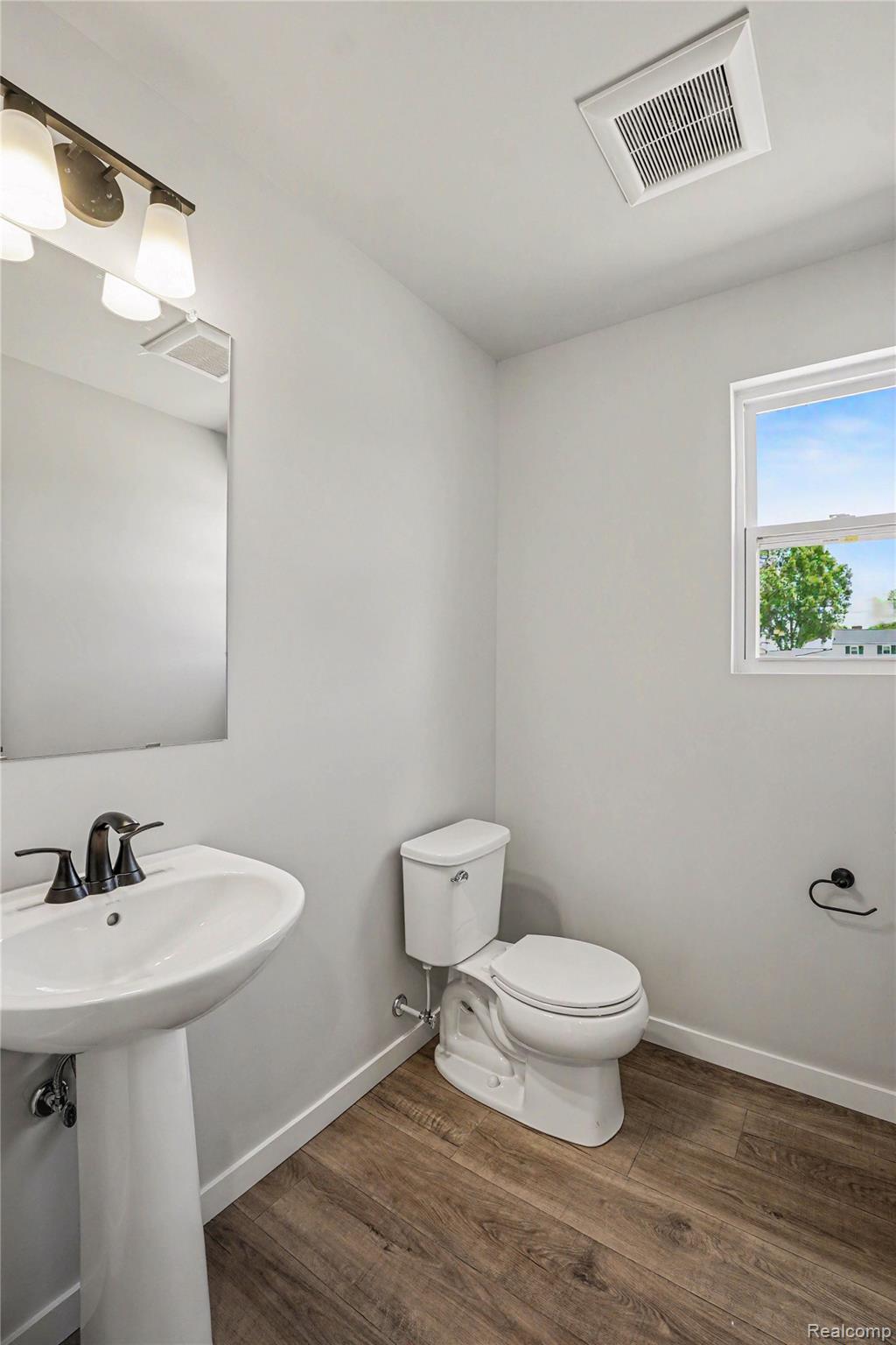 6030 Lahring Road Linden, MI 48451 - Photo 9 of 36 The powder room is conveniently located on the first floor.