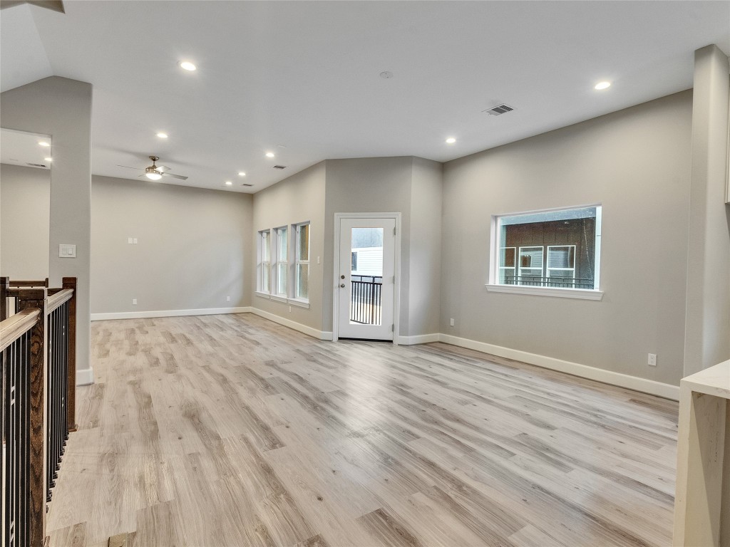1122 West 16th Street, Unit C Houston, TX 77008 - Photo 18 of 38 a view of an empty room with wooden floor and a window