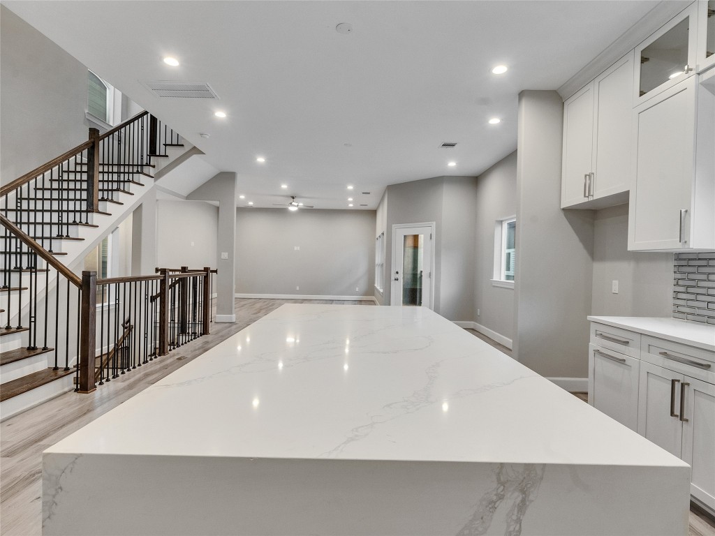 1122 West 16th Street, Unit C Houston, TX 77008 - Photo 19 of 38 a large white kitchen with wooden floor and a sink