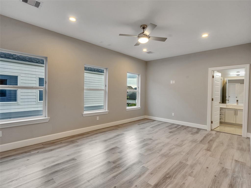 1122 West 16th Street, Unit C Houston, TX 77008 - Photo 30 of 38 a view of an empty room with a window and wooden floor