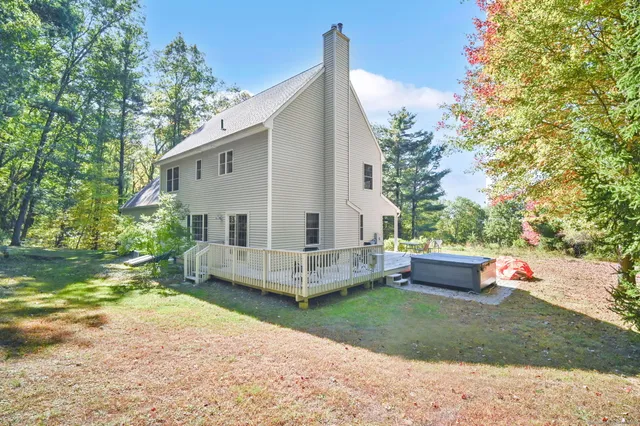 a view of a house with a yard and sitting area
