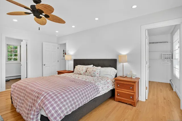 a bedroom with a bed and wooden floor